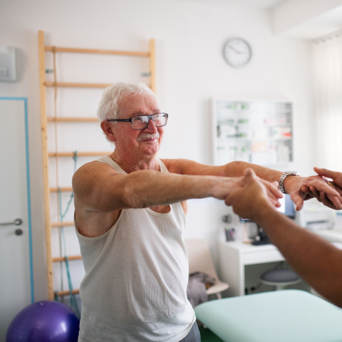 senior male exercising with doctor