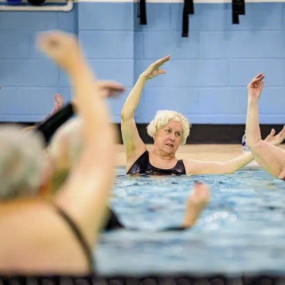 senior male exercising with doctor